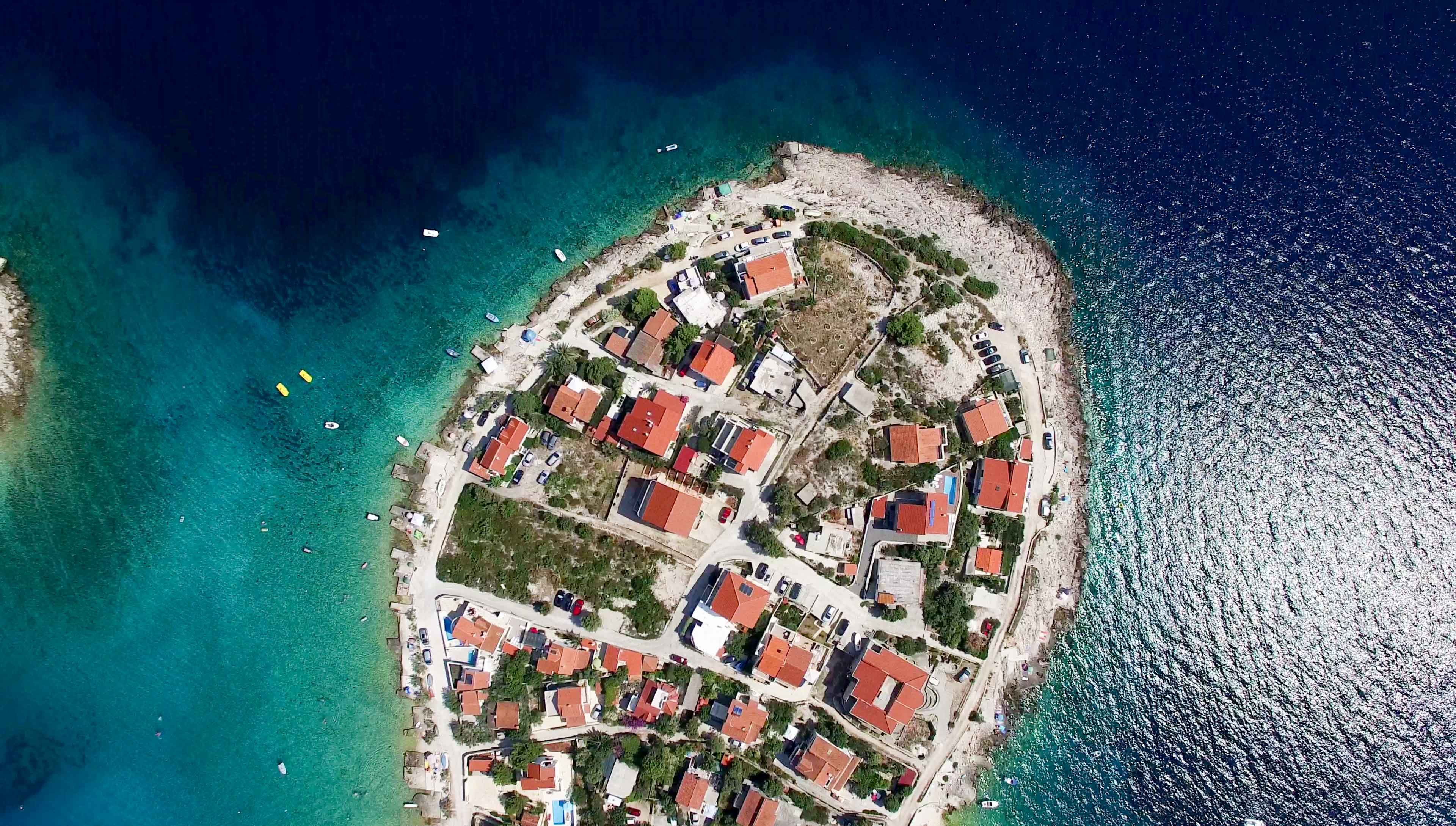 An aerial view of a Croatian Adriatic island with turquoise waters
