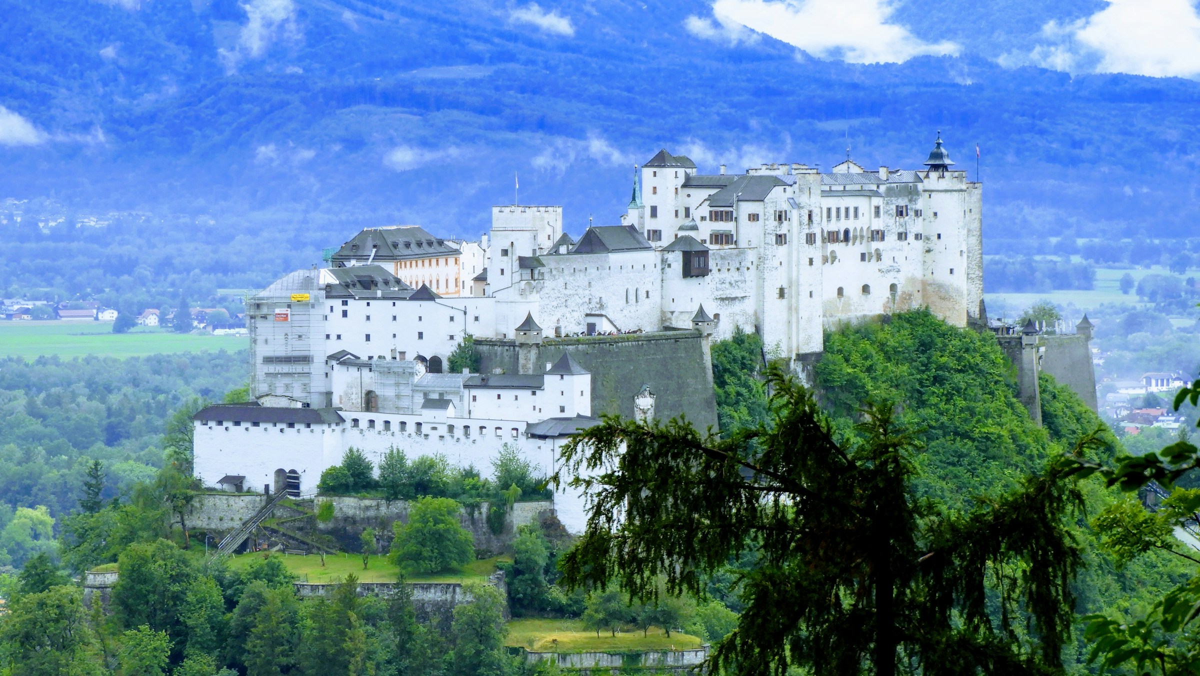 A large white castle on top of a hill
