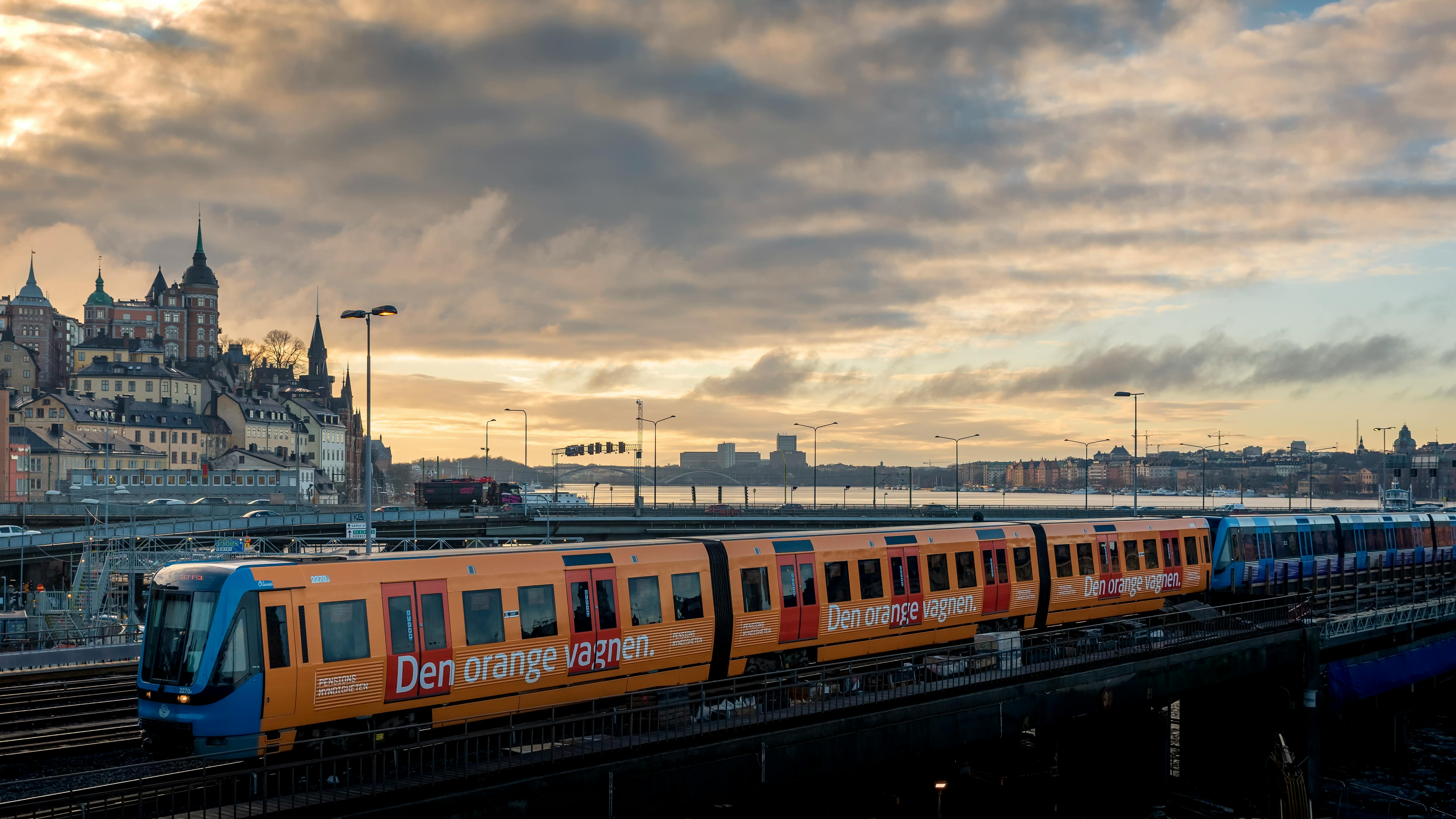 A sleek train glides through the Nordic landscape at dusk