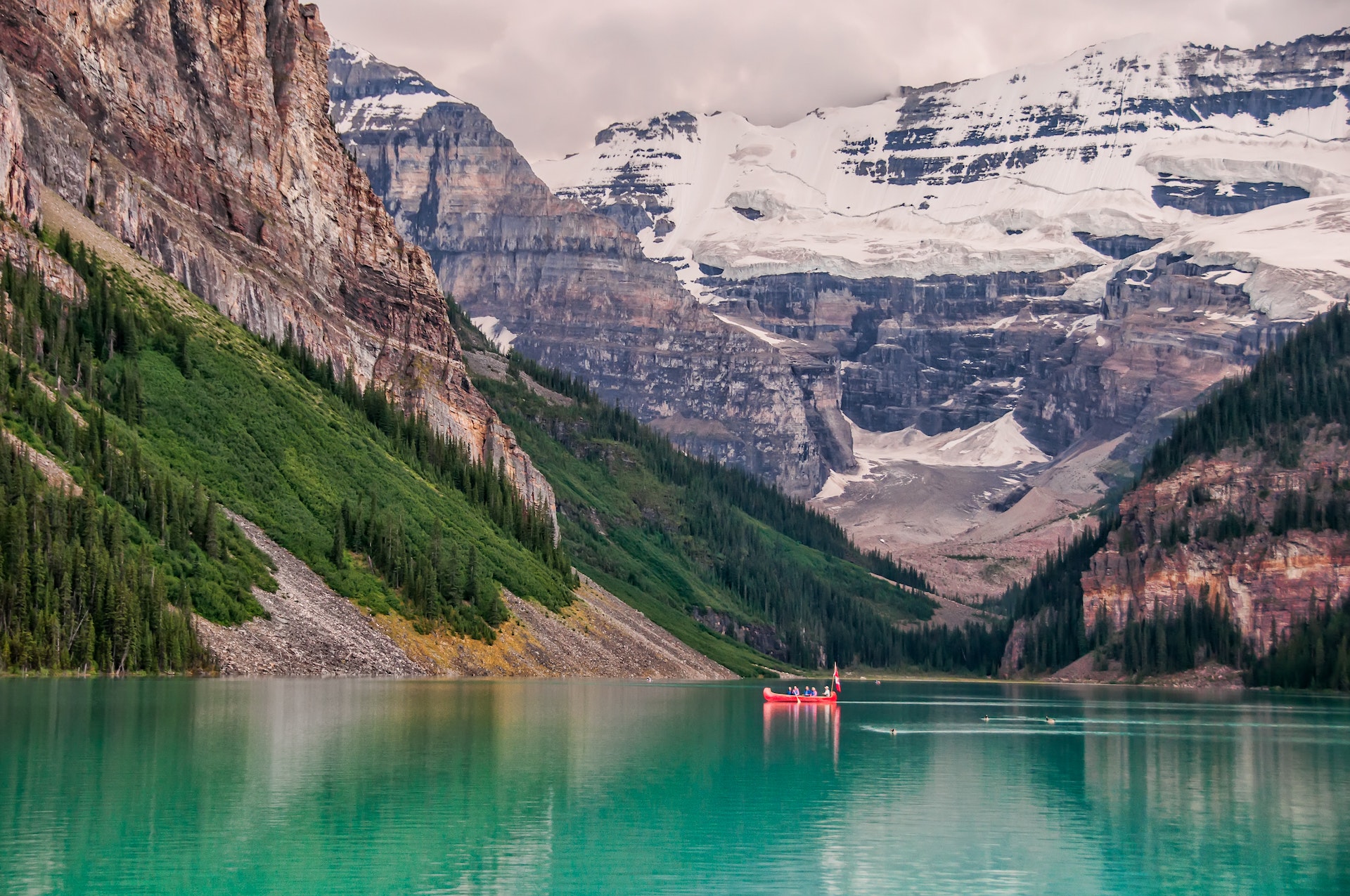 Lake Louise at Banff National Park during the spring, when the mountains in its backdrop still have snowy peaks.