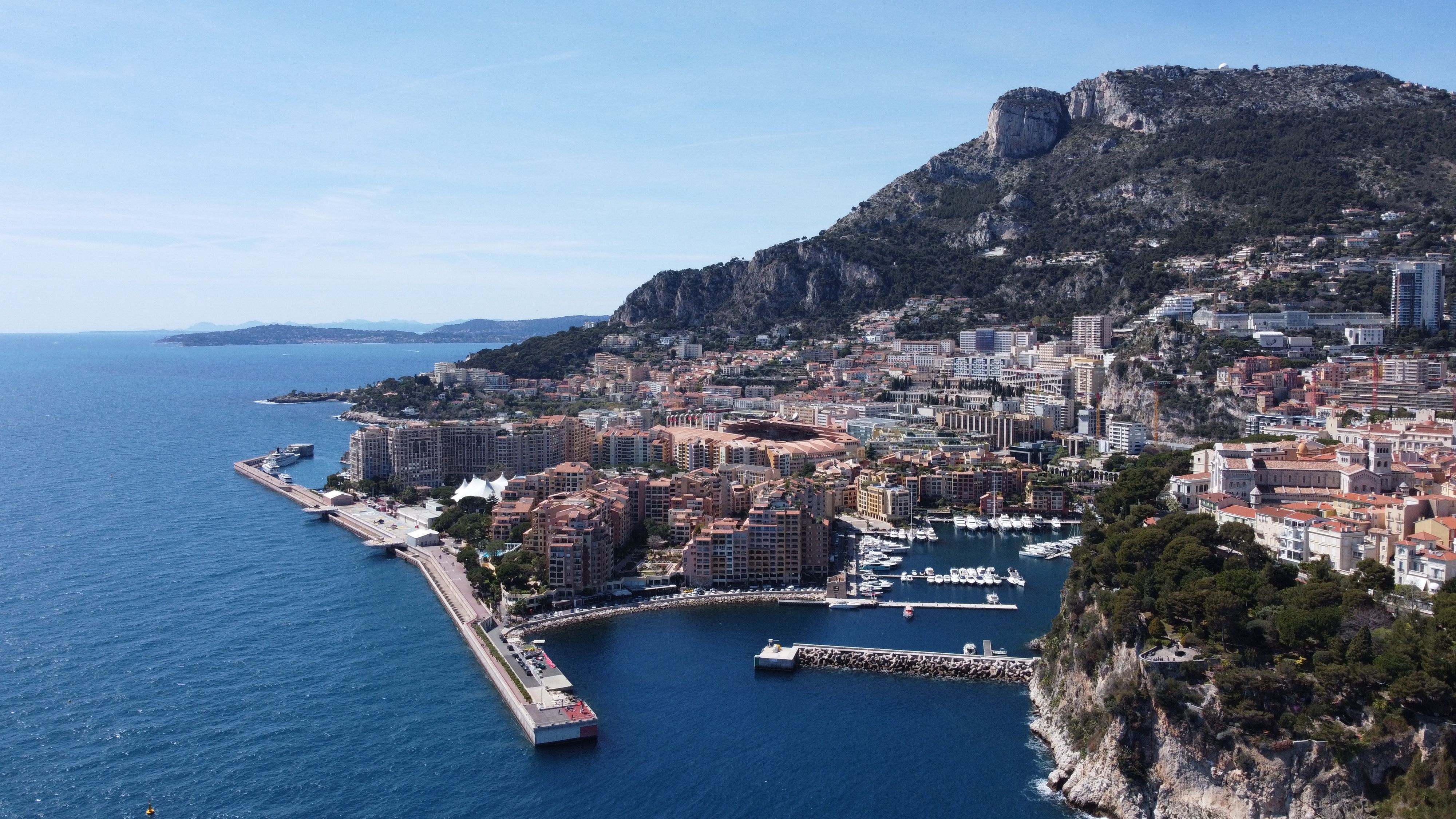 Panoramic view of Monaco's coastline, marina and city skyline along the French Riviera