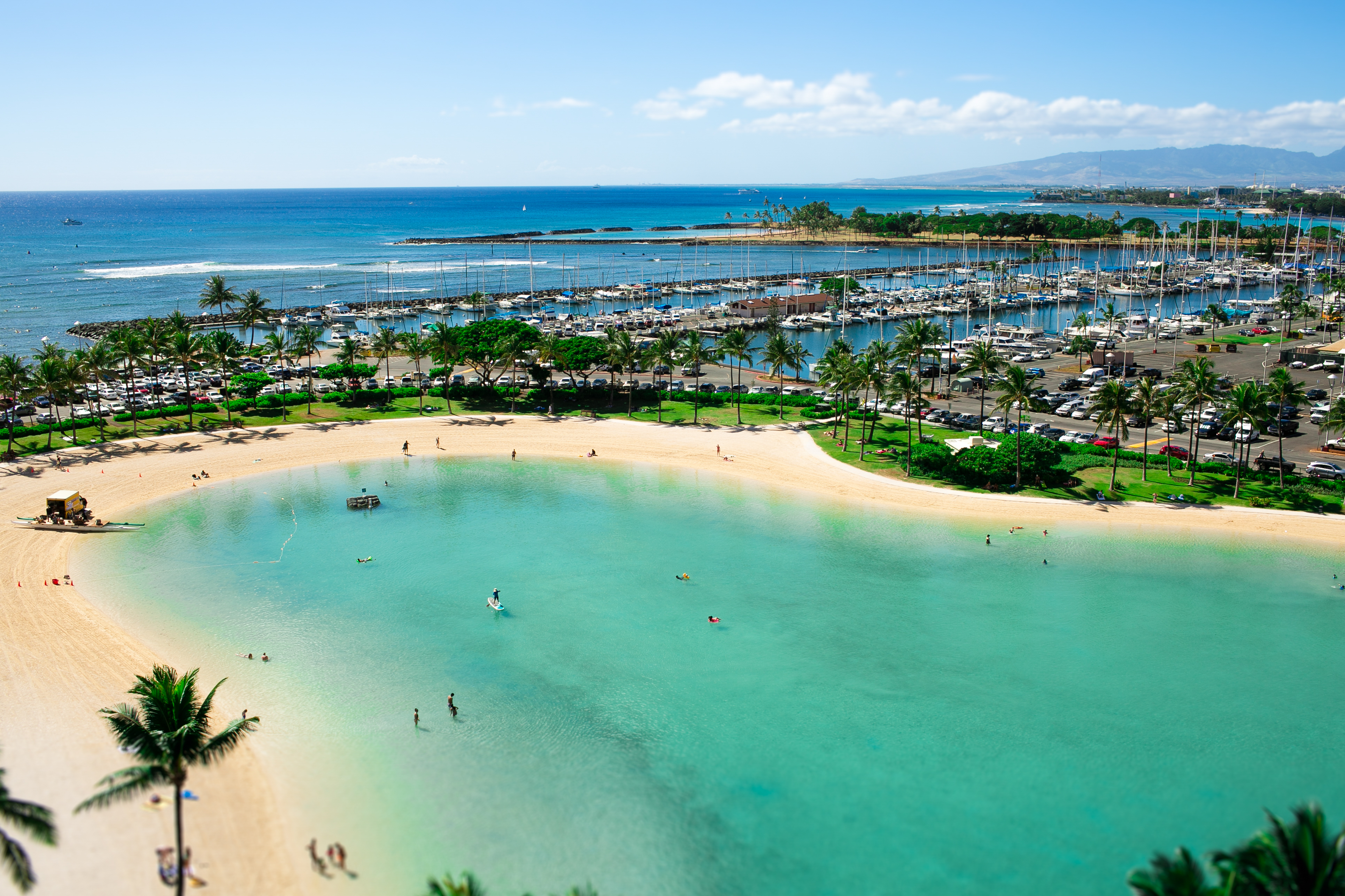 Golden sands meet calm turquoise waters on a sunlit beach in New Caledonia