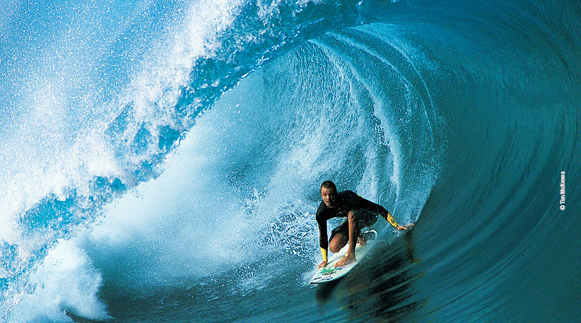 Surfers brave some of the highest and most challenging waves of Tahiti.
