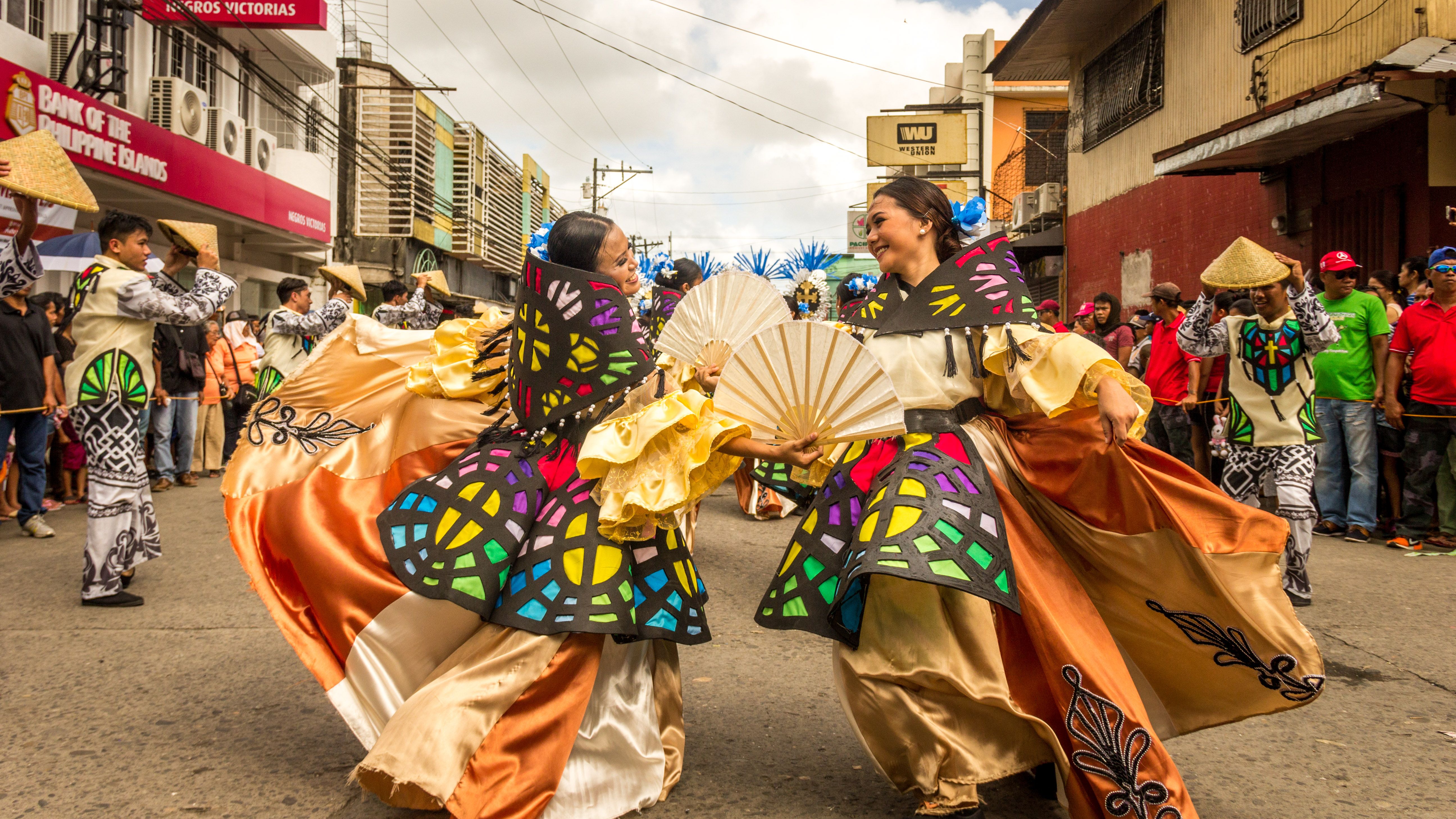 Traditional Philippine cultural festival featuring performers in colourful attire celebrating local heritage and community traditions