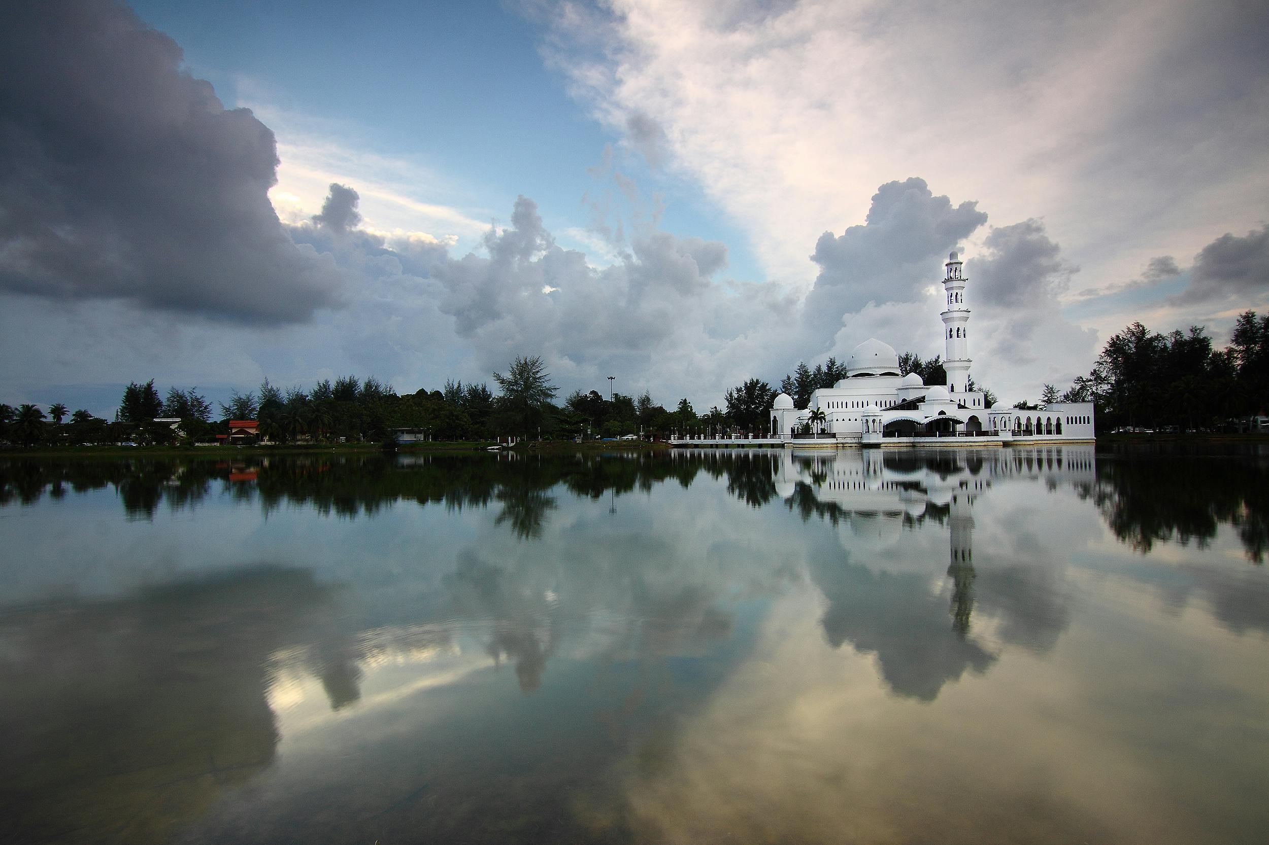 A majestic white temple stands under clear blue skies