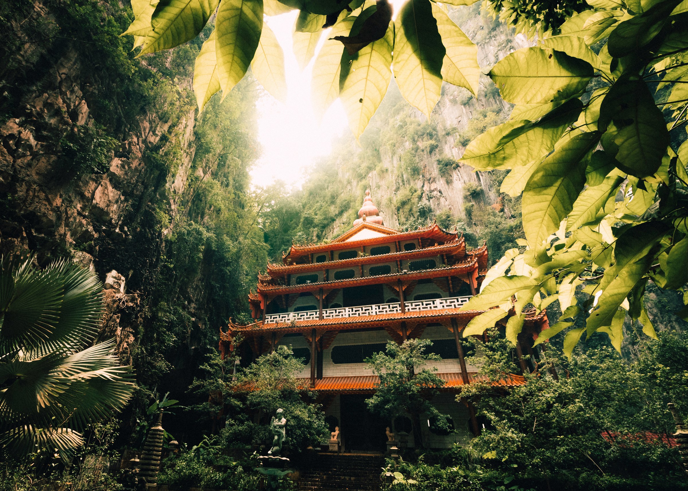 A temple surrounded by greenery and mountains