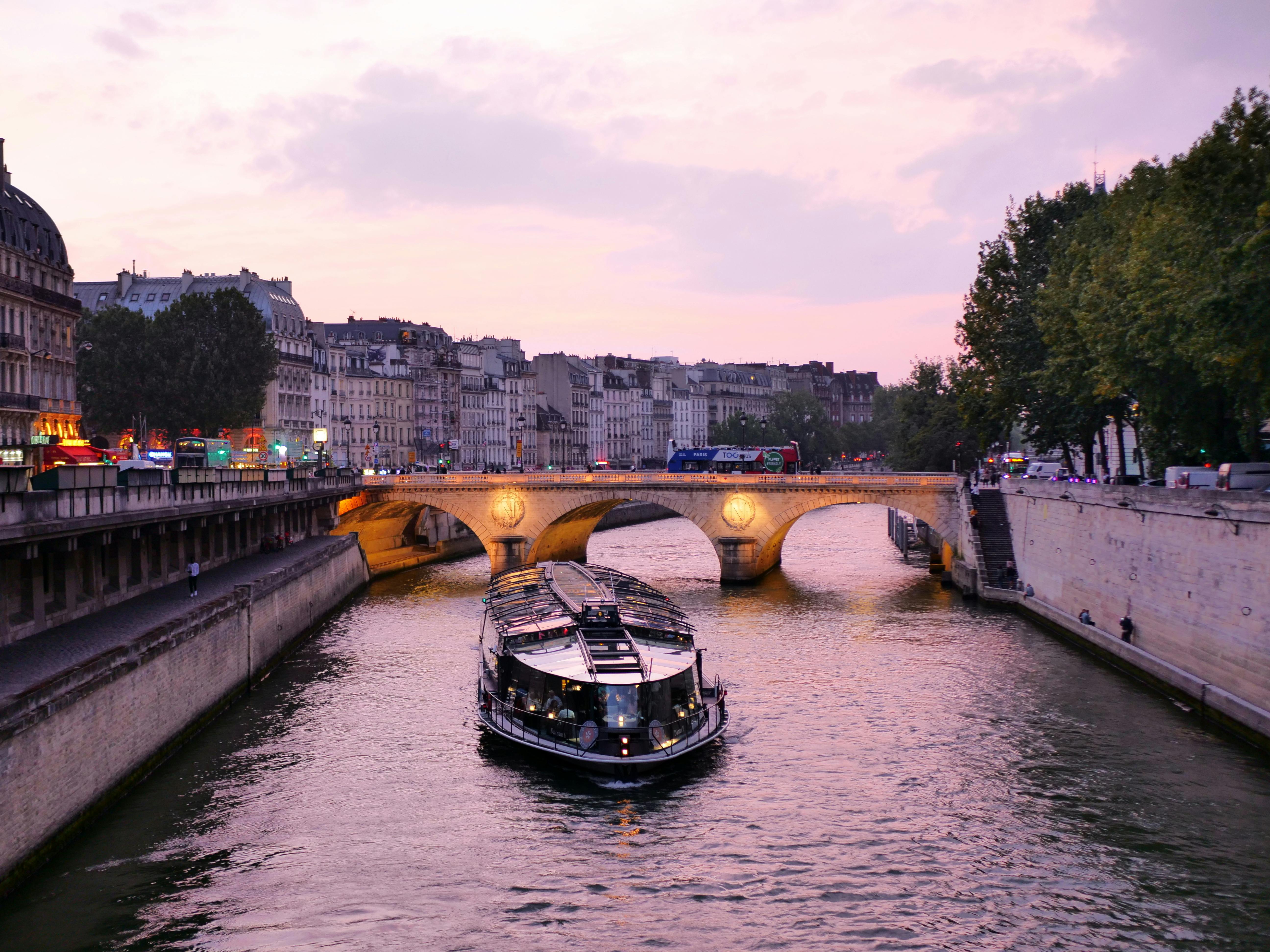 A tranquil river scene with calm waters and historic architecture