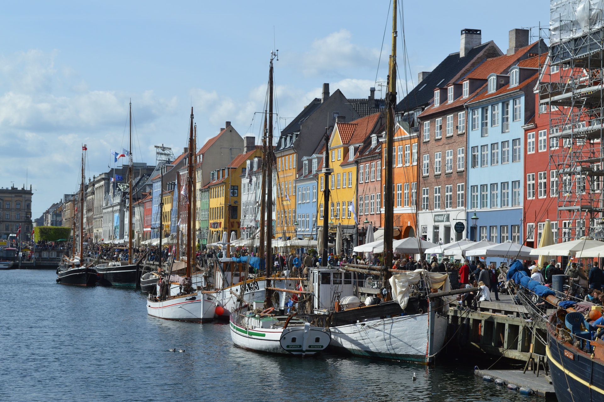 Colourful houses and boats lining the harbour of Nyhavn in Copenhagen.