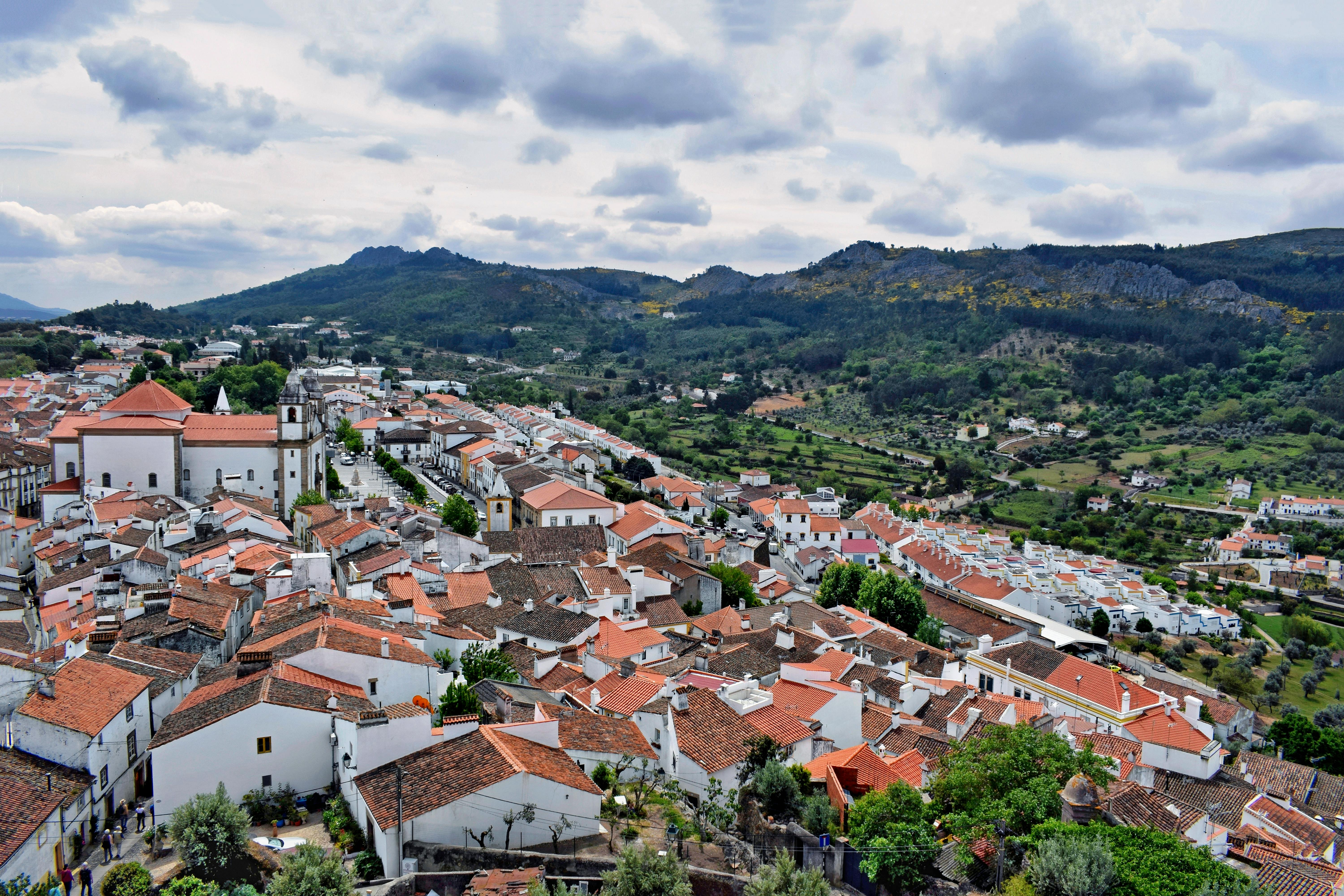 An aerial view of a quaint village nestled among rolling hills