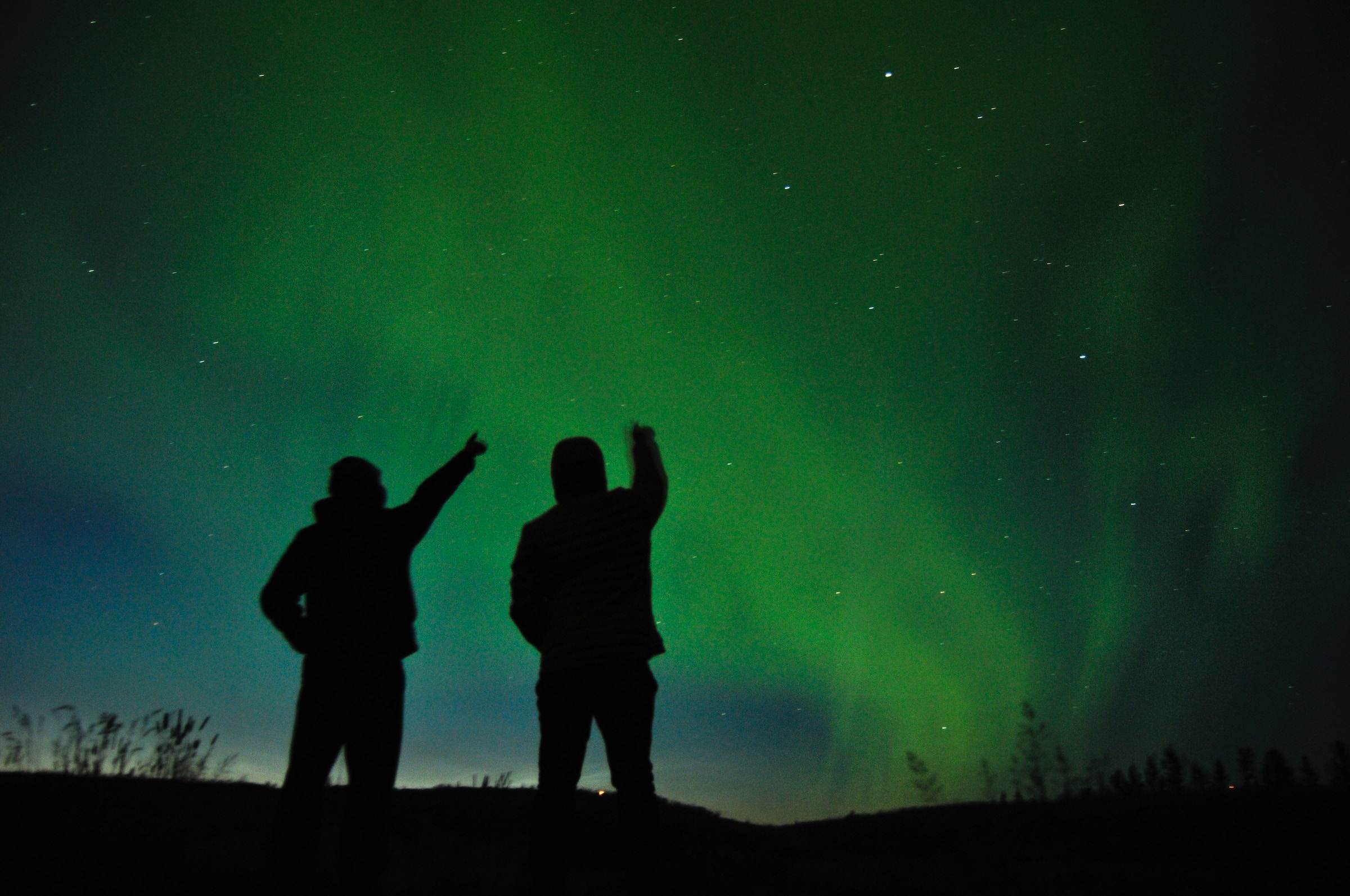 Travellers looking at Aurora Borealis