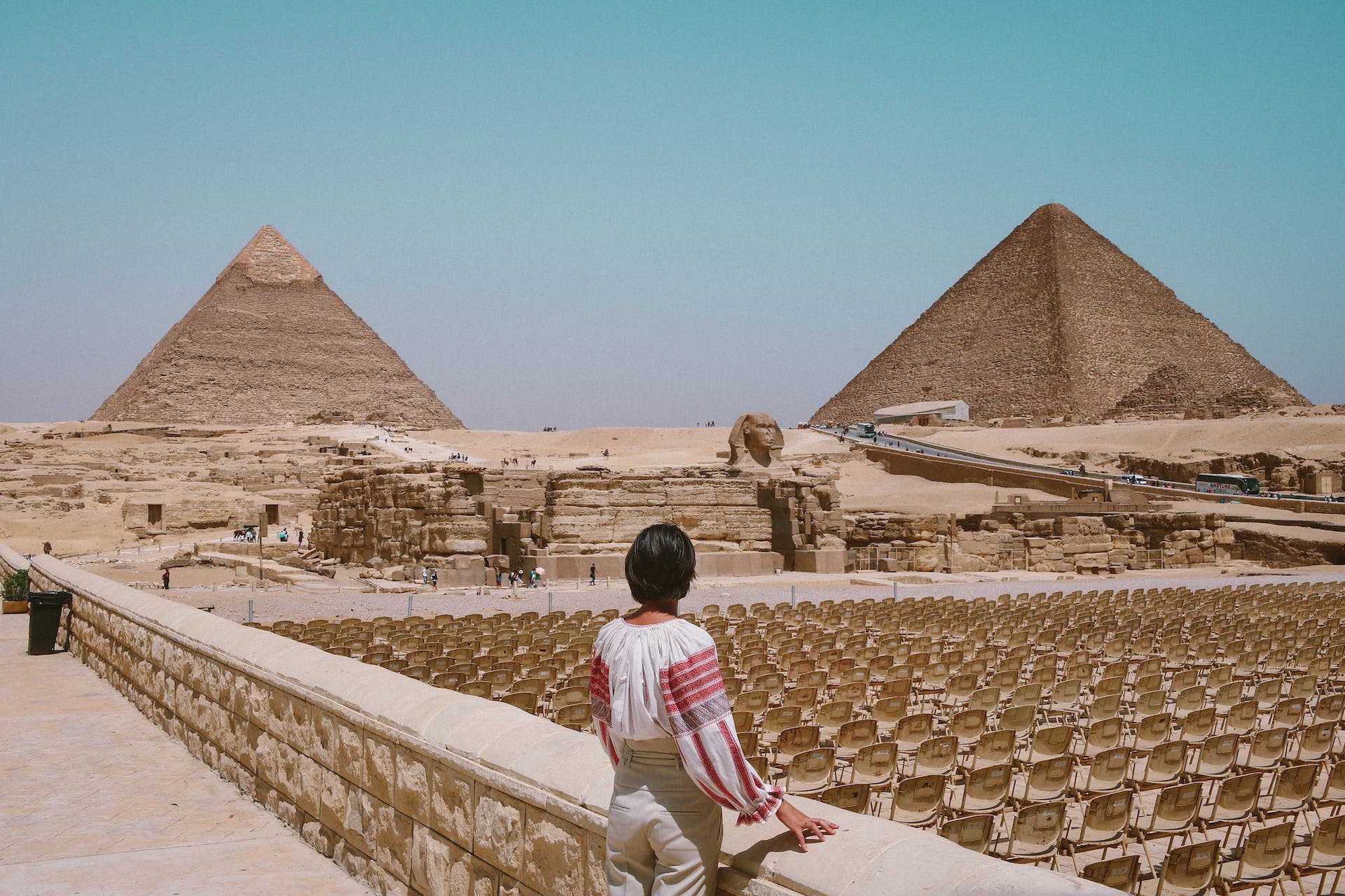A person looking over at the pyramids and Sphinx of Egypt