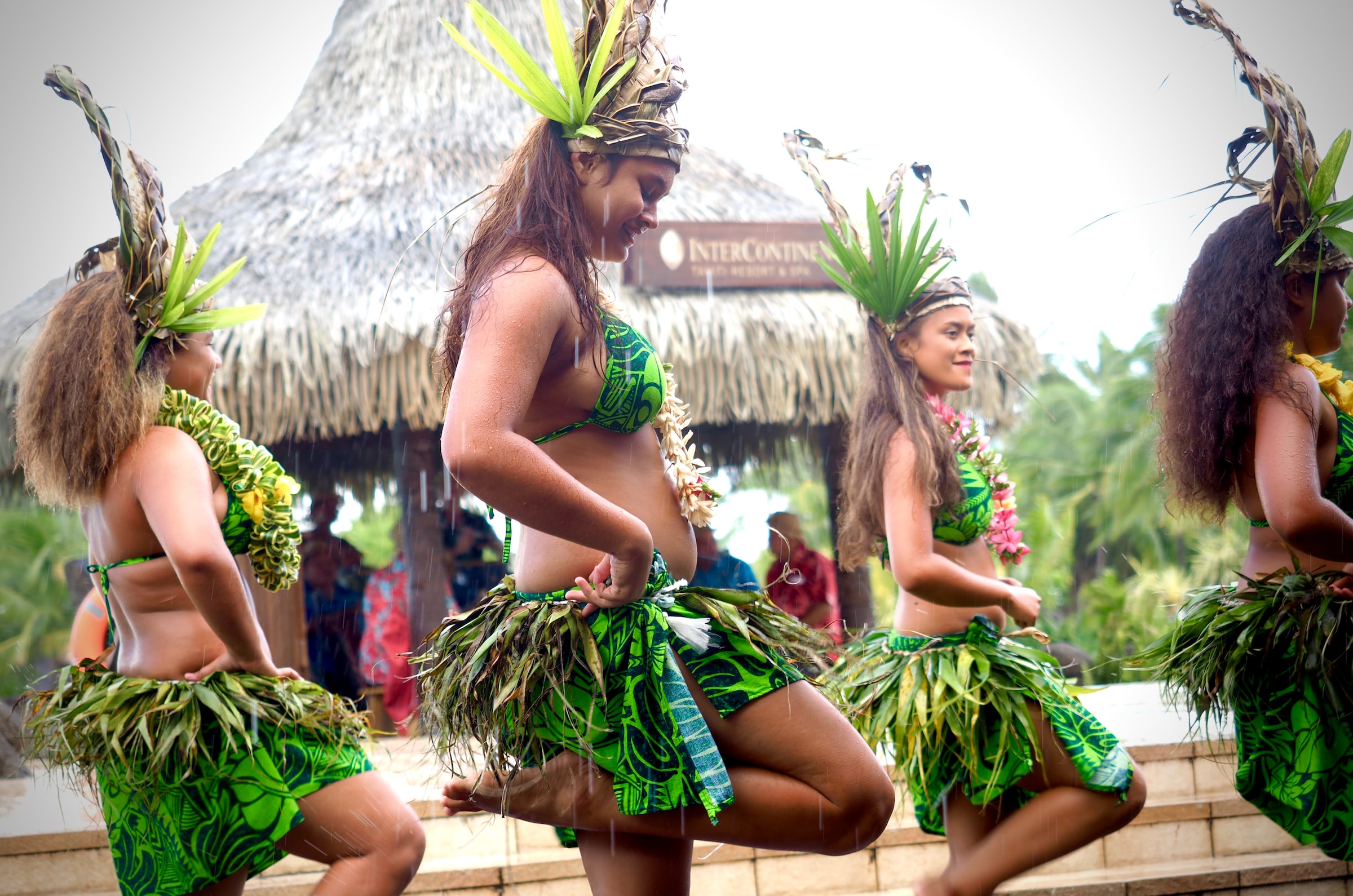 Tahitian women in costume doing a traditional dance.