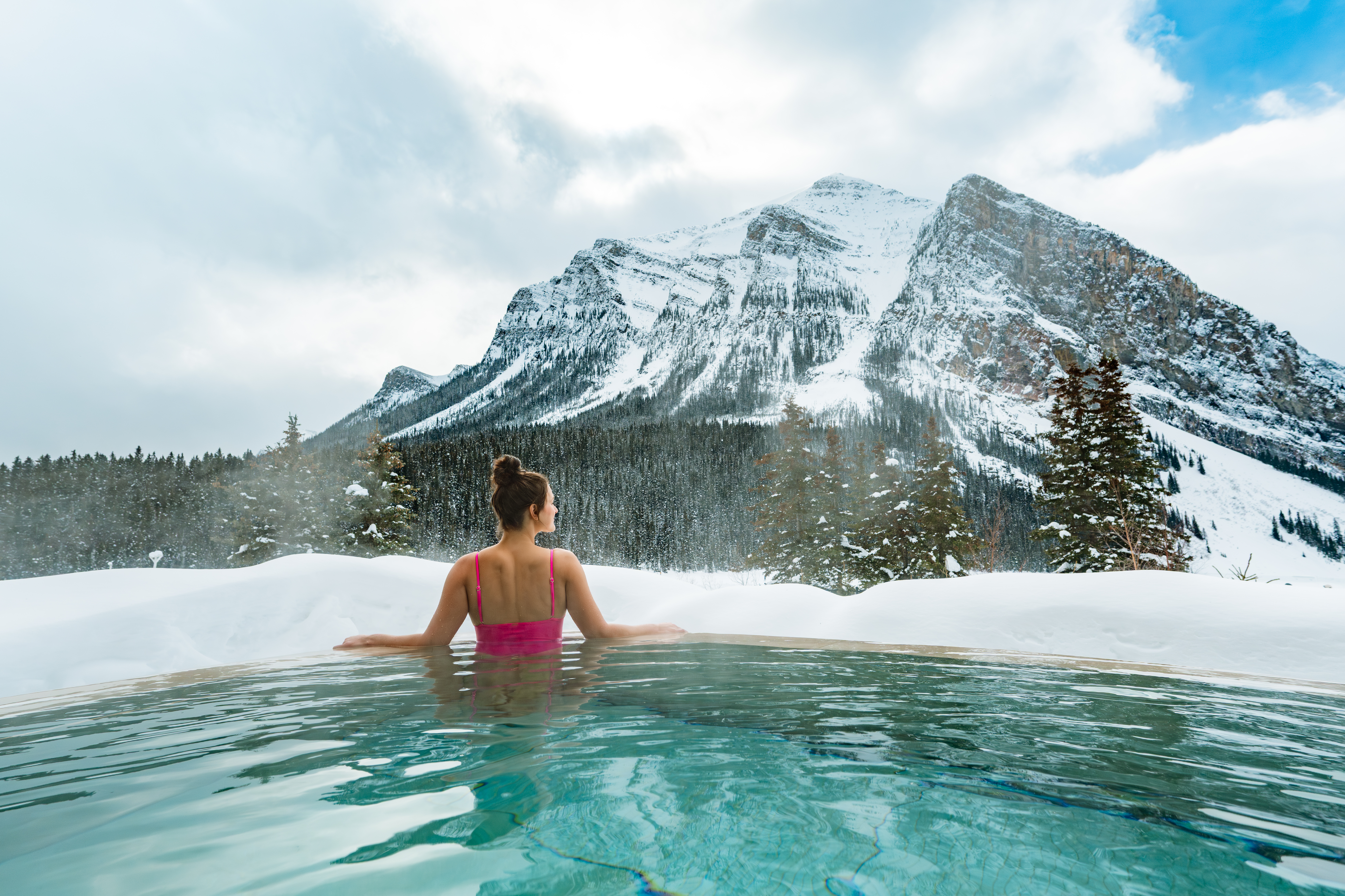 A striking view of Moraine Lake’s vivid blue waters framed by rugged mountain peaks and evergreen forests