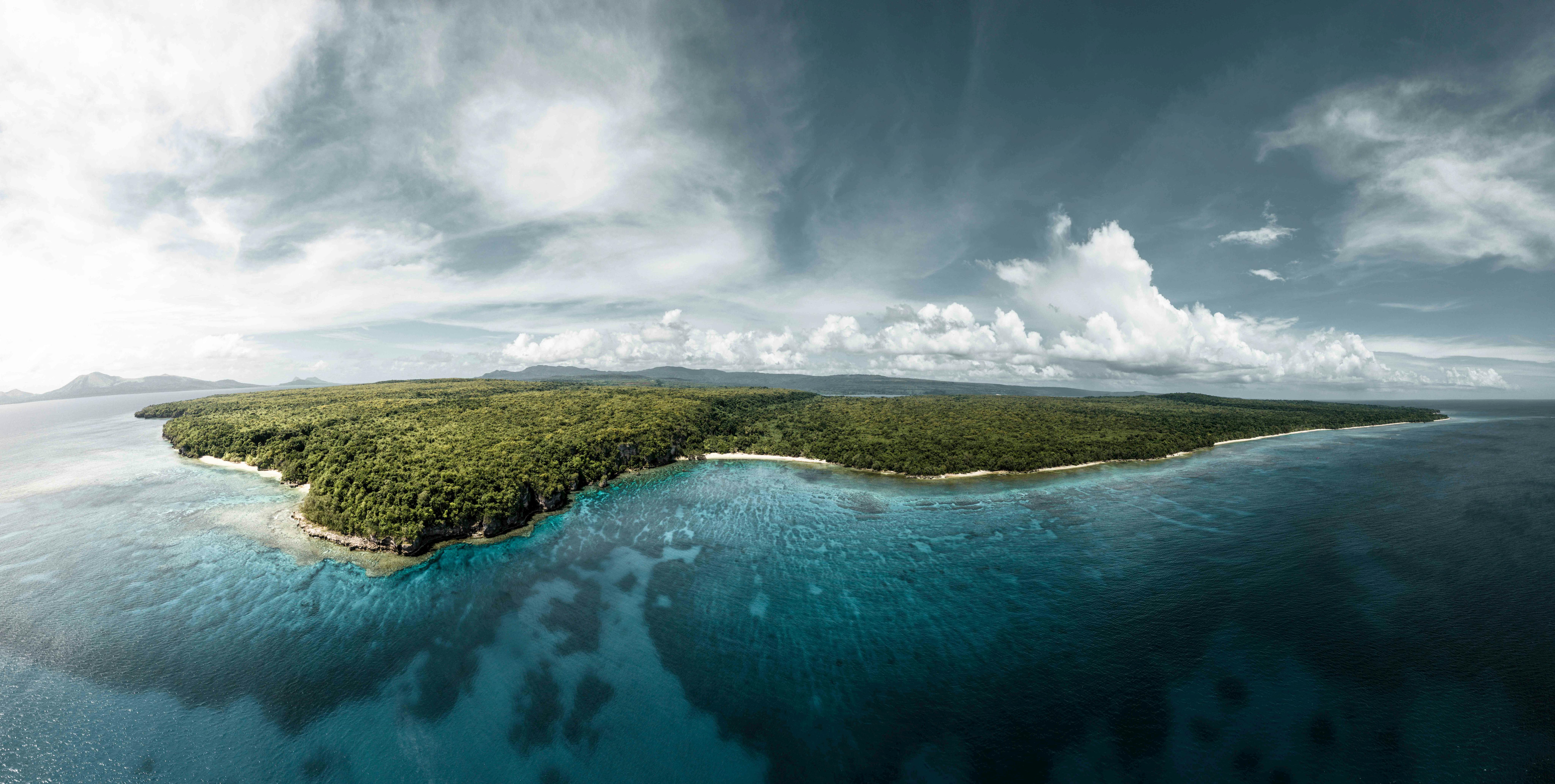 Aerial view of a lush Vanuatu island surrounded by turquoise waters